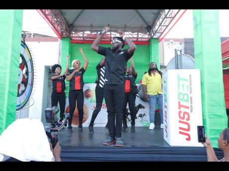 Credit: Contributed Fyahman and the JustBet dancers kept the place lit during the Ballin with JustBet outside broadcast, at the Half-Way Tree Transport Centre in St Andrew.
