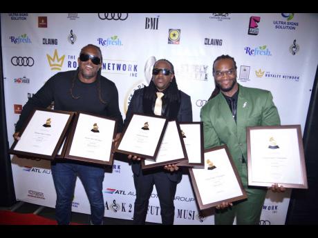 Credit: Antoine Lodge The members of T.O.K. (from left) Roshaun ‘Bay-C’ Clarke, Alistaire ‘Alex’ McCalla and Craig ‘Craigy T’ Thompson, pose with their Grammy certificates.