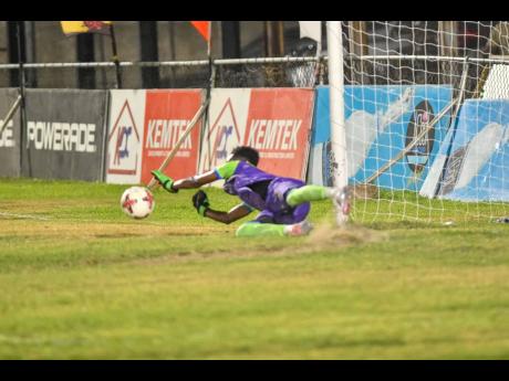 Credit: Matthew McKoy Goalkeeper Garwin Davis of Harbour View FC dives to make a save from a free kick during the Jamaica Premier League football match against Waterhouse Football Club at Drewsland Mini-Stadium in St Andrew last night. Harbour View won 2-1.
