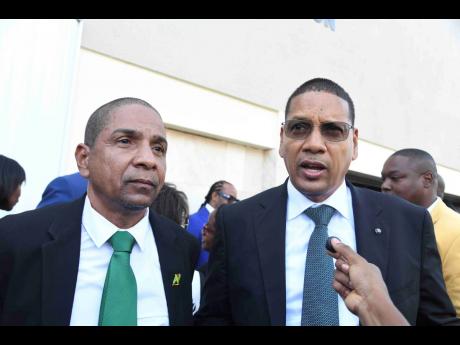 Brothers Delory (left) and Donovan Williams at the swearing-in ceremony for parliamentarians at Gordon House on Thursday.