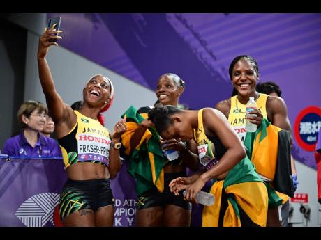 Credit: Gladstone Taylor/Multimedia Photo Editor Shelly-Ann Fraser-Prycee (left) celerates her 17th World Championship medal, a silver in the women's 4x100 metres, by taking a selfie with her teammates from left: Tina Clayton, Tia Clayton, and Jonielle Smih.