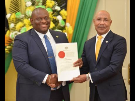 Senator Marlon Morgan being sworn in as  Parliamentary Secretary in the Ministry of Education, Skills, Youth and Information. Morgan is the lowest paid member of the political executive. He earns $1.4 million per month or just over $17 million a year.