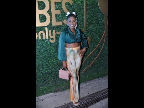 Credit: Antoine Lodge Kadesha Brydson, customer service representative, dons a green crop blouse paired with high-waisted flare trousers.