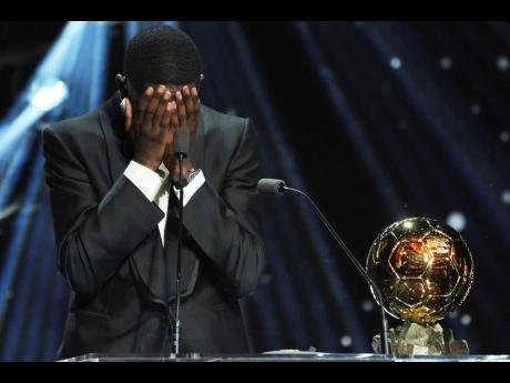 Paris Saint-Germain’s Ousmane Dembélé reacts as he receives the 2025 Men’s Ballon d’Or during the 69th Ballon d’Or awards ceremony at the Theatre du Chatelet in Paris, Monday, Sept. 22, 2025. (AP Photo/Thibault Camus)