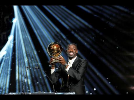 Paris Saint-Germain's Ousmane Dembélé receives the 2025 Men's Ballon d'Or during the 69th Ballon d'Or awards ceremony at the Theatre du Chatelet in Paris yesterday.