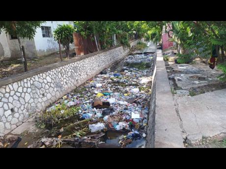 Credit: Almando Smith The gully is still laden with garbage and other debris.