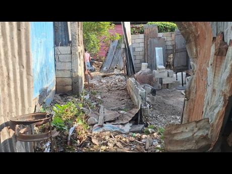 Credit: Almando Smith This yard shows the aftermath of last Friday’s flooding in Burger Gully.
