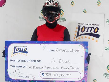 Credit: Contributed The first Lotto millionaire of 2025 proudly displays her cheque during the handover at the Supreme Ventures Limited Twin Gates store In St Andrew.