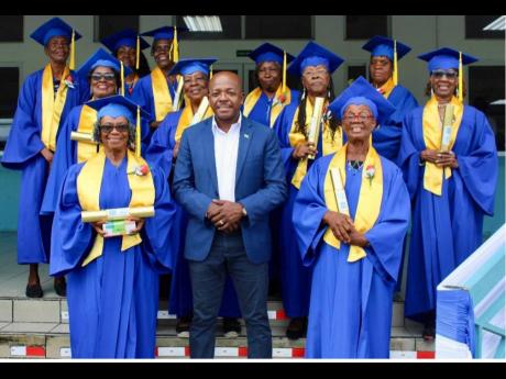 Credit: Contributed Labour and Social Security Minister Pearnel Charles Jr (centre, front row) with graduates of the National Digital Literacy Programme at the recent graduation ceremony.