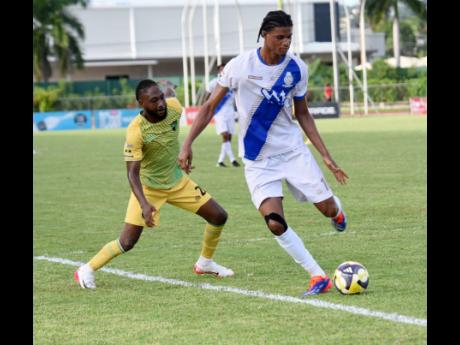 Credit: Ashley Anguin Harbour View FC’s defender Garth Stewart (right) attempts to clear the ball away from Treasure Beach FC’s Jhanni Flemmings during their Jamaica Premier League football match at Montego Bay Sports Complex yesterday. The game ended 1-1.