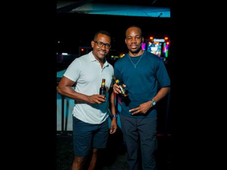 Credit: Contributed Mello Vibes promoter Omar Perrin (left) links up with Lasana Wilson, junior brand manager for Guinness, while celebrating a night bursting with music, culture, and pure Mello Vibes magic.