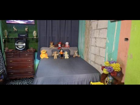 Credit: Almando Smith Tiny treasures on the children's well-made bed demonstrates a father’s gentle touch.