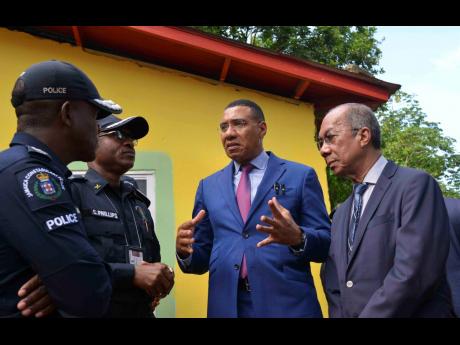 Credit: Photos by Antoine Lodge /Photographer Prime Minister Dr Andrew Holness (second right) in dialogue with Deputy Prime Minister and Minister of National Security Minister, Dr Horace Chang (right), Police Commissioner Dr Kevin Blake (left) and Assistant Commissioner of Police for Area 5, Christopher Phillips, as they visited the Commodore area following the tragedy.