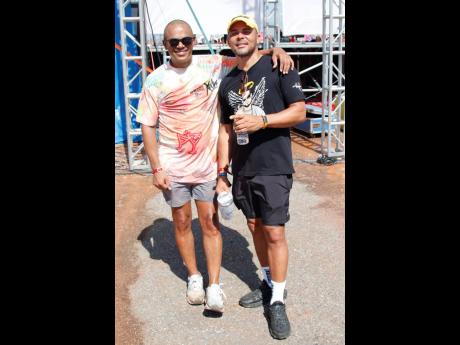 Scott Dunn (left), group managing director of Dream Entertainment Ltd., hangs with Walshy Fire from Major Lazer.