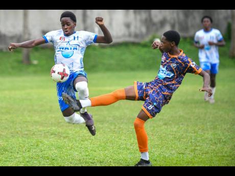 Riquelme Campbell (left) of Hillel Academy is fouled by Jazari Dillon of Dunoon Park Technical High during the ISSA WATA Manning Cup football match at Hillel Academy on September 27.