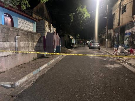 Police investigators at the scene of Tuesday night’s shooting in Kingston.