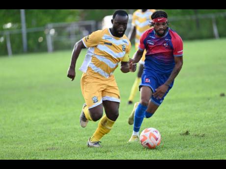 Credit: Rudolph Brown Molynes United’s Jason Wright (left) dribbles past Dunbeholden’s Chevoy Watkin during a Jamaica Premier League contest.