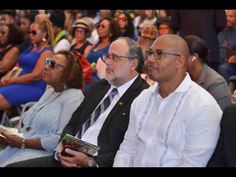 Credit: Antoine Lodge From left: Minister of of Culture, Gender, Entertainment and Sport Olivia ‘Babsy’ Grange; Leader of the Opposition, Mark Golding; and Member of Parliament for Manchester North Western Mikael Phillips watch proceedings at the thanksgiving service for Allan ‘Skill’ Cole at the National Arena on Saturday.
