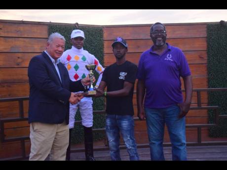 Jockey Reyan Lewis, after riding UNSPUN to victory, looks on as connections receive the TYPEWRITER Trophy at Caymanas Park on Sunday, September 28.