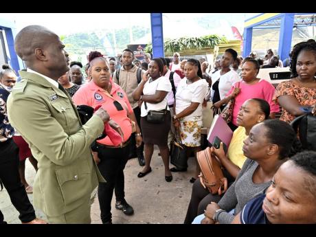 Aspiring correctional officers listen attentively as Staff Officer Jason Anderson offers guidance during the 2025 recruitment exercise.