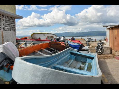 The sea appears calm in Port Royal on Thursday, as some residents say Tropical Storm Melissa will not force them from their homes. 