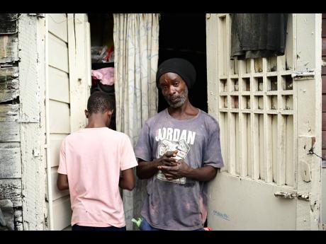 Credit: Photos by Gladstone Taylor/Multimedia Photo Editor Jeffery Walker and his son Javoy at their home in Greenwich Town.