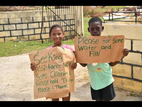 Credit: Matthew McKoy Photos Hungry children gather by the roadside in Oxford, St Elizabeth, hoping for a helping hand after Hurricane Melissa.