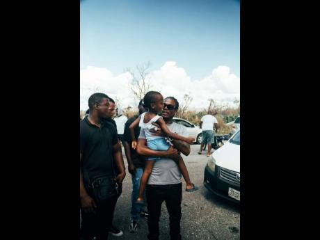 Credit: Contributed Masicka comforts a baby who lost her home during Hurricane Melissa’s passage.