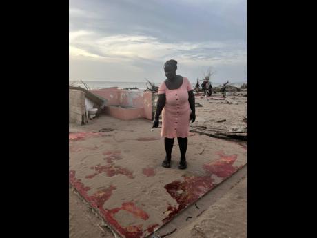 Credit: Photos by Ashanti Lawson Sheron Watson standing on what was once her living room in Parottee, St Elizabeth.