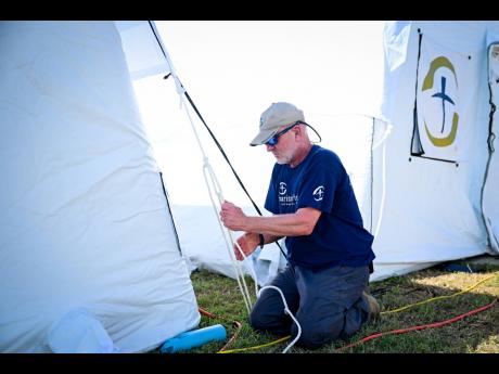 A member of the build team with the Samaritan’s Purse International Relief, Charlie Geer, puts the final touches on the hospital.