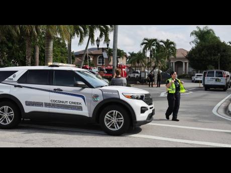 Credit: Carline Jean Emergency personnel from Coral Springs and Coconut Creek are on scene where a plane crashed in the Windsor Bay community in Coral Springs on Monday, Nov. 10, 2025. (Carline Jean/South Florida Sun-Sentinel via AP)