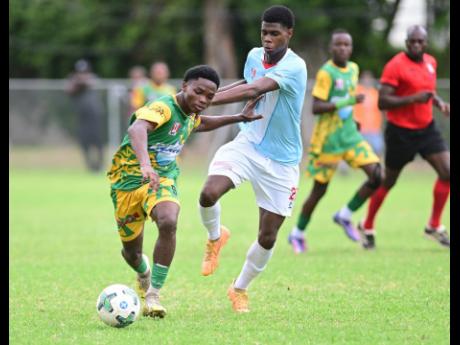 Credit: Gladstone Taylor/Multimedia Photo Editor Kimarly Scott of Excelsior High School (left) is challenged by Kevaughn Brown of St George’s College during their ISSA WATA Manning Cup football match at Winchester Park, St. George’s College on Saturday, October 11.