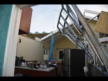 Credit: Ian Allen/Photographer The roof of this home in Montego Bay, St James was badly damaged.
