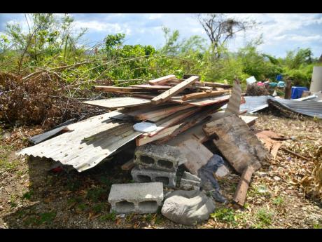 Credit: Photos by Matthew McKoy Pieces of board, zinc and blocks are remnants of a dwelling in Board Scheme.