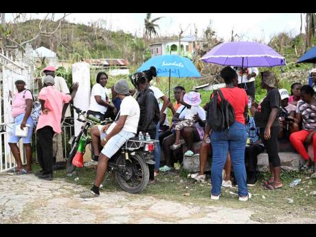 Credit: Ricardo Makyn Residents line up at the World Central Kitchen site in Beeston Spring, Westmoreland, receiving much-needed meals following Hurricane Melissa.
