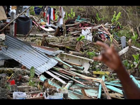 Credit: Ricardo Makyn Miller shows the damage to her property.