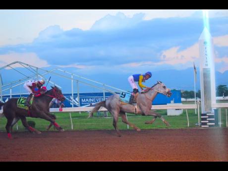 MOJITO (right), ridden by Raddesh Roman, wins the Jamaica Cup ahead of  GIRVANO (Tevin Foster) at Caymanas Park yesterday.