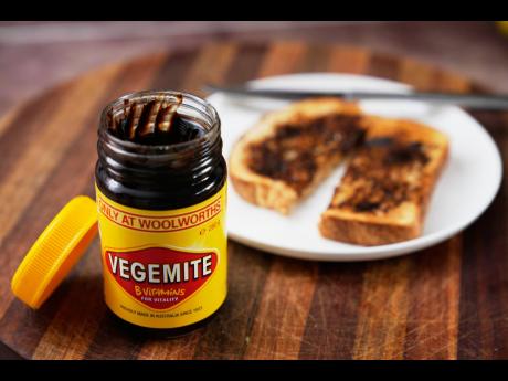 A piece of toast is prepared with Vegemite in Sydney, Australia. 