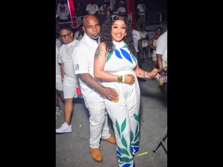 Credit: Anthony Minott Clive Heavy Hitters (left), promoter of Board Meeting, stepping out with his queen — class and prestige.