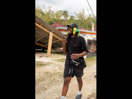 Beres Hammond’s road manager and operations coordinator at Harmony House studio, his son Rasheed Hammond, tours Westmoreland recently while assisting in the efforts to aid those affected by Hurricane Melissa. 
