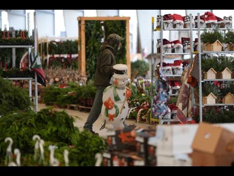 A worker transports holiday decorations at the auction. 