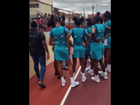 Credit: Raymond Graham Coach Winston Nevers (left partially hidden) of Denbigh High gives instructions to his team during half-time break in their top of the table ISSA rural under-16 clash with Glenmuir High yesterday at Glenmuir.