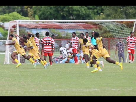 Credit: Nathaniel Stewart Garvey Maceo High School players celebrate scoring the winning goal during their ISSA daCosta Cup football match against Glenmuir High at Glenmuir High School on Wednesday, October 8. Garvey Maceo won 3-2.