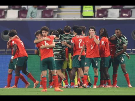 Portugal players celebrate a goal during the FIFA U17 World Cup final soccer match against Austria in Doha, Qatar on Thursday.