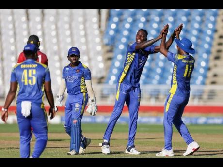 Credit: Photo by CWI Media Dominic Drakes (second right) celebrates one of his four wickets against lthe Trinidad and Tobago Red Force during the final of the CG United Super50 cricket competition at the Brian Lara Cricket Academy on Saturday.