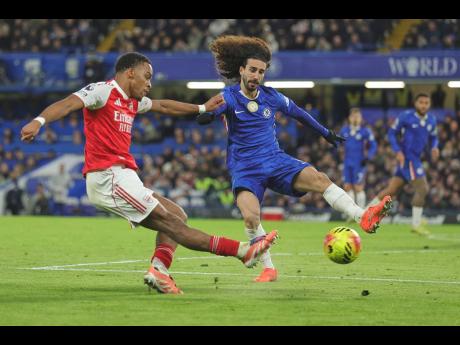 Credit: AP Arsenal’s Jurrien Timber (left) kicks the ball ahead of Chelsea’s Marc Cucurella during the English Premier League soccer match at Stamford Bridge in London, England, yesterday, The game ended 1-1.