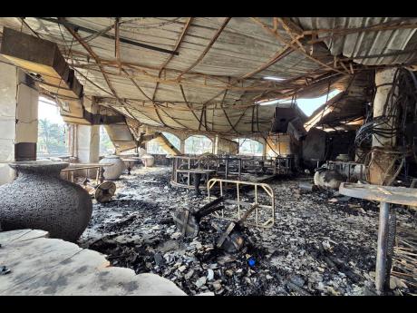 The charred interiors of a nightclub, which caught fire early Sunday, are seen in Arpora, Goa, India. 