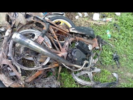 A burnt-out motorcycle that was involed in a crash.