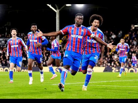 Crystal Palace’s Marc Guehi celebrates after scoring his side’s second goal during the English Premier League soccer against Fulham in London, England, yesterday. Palace won 2-1.