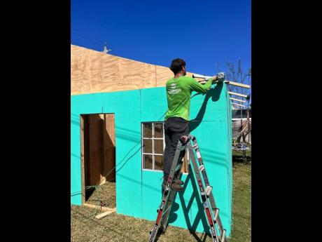Credit: Contributed A member of Ground Force Humanitarian Aid works on a dwelling.